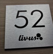 silver nameplate with the room number